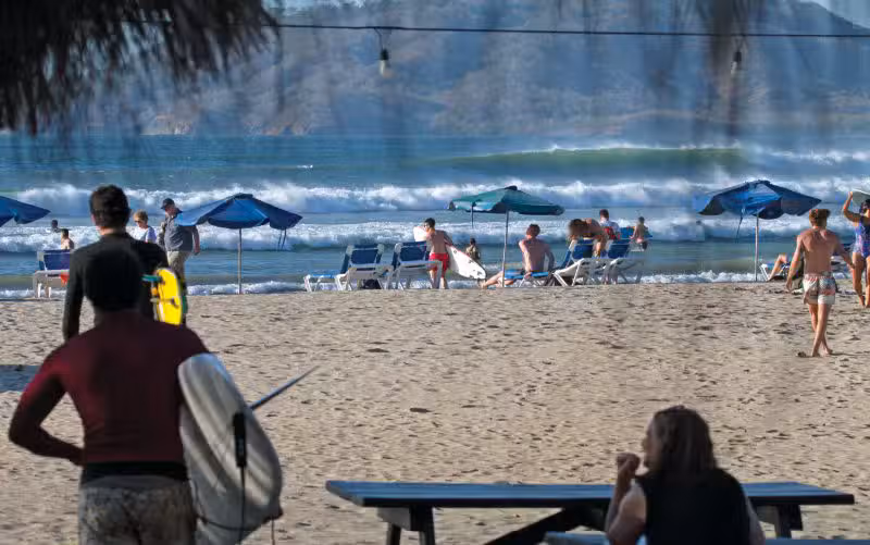 watching surfers on the beach tamarindo costa rica